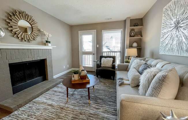 an open living room with a fireplace and a couch