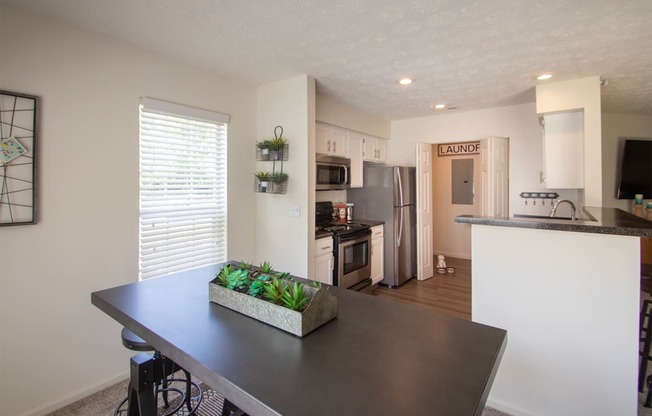 This is a photo of the kitchen from the diding room of the 1100 square foot 2 bedroom Kettering floor plan at Washington Park Apartments in Centerville, OH.