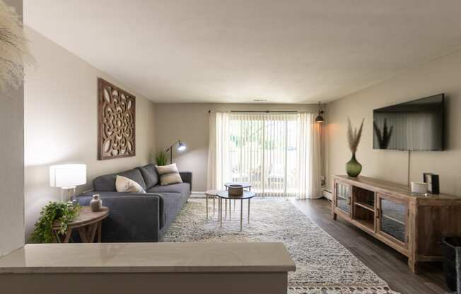 This is picture of the living room and patio in the 823 square foot 2 bedroom apartment at Aspen Village Apartments in the Westwood neighborhood of Cincinnati, OH.