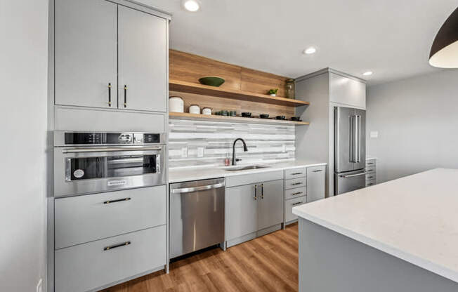 A modern kitchen with stainless steel appliances and wooden accents.