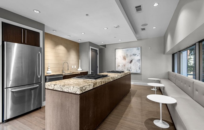 a large kitchen with granite counter tops and stainless steel appliances