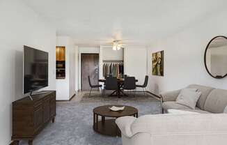 a living room with a couch and a table and a television at Pheasant Park Apartments, New Hope, MN, 55428-5401