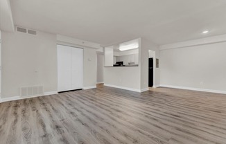a bedroom with hardwood floors and white walls