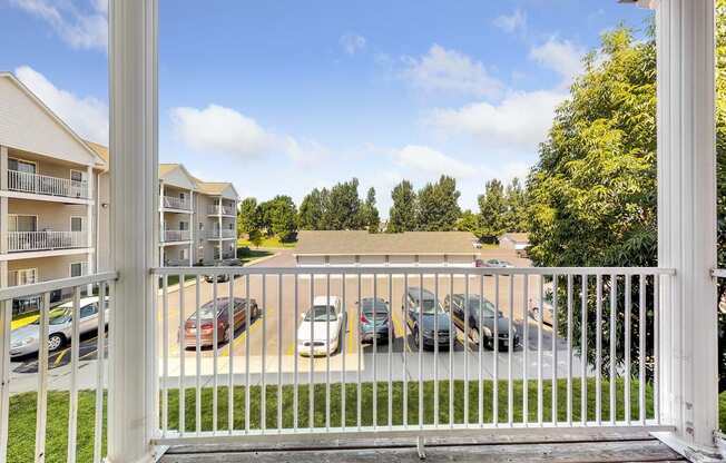 a view of the parking lot of an apartment complex with cars