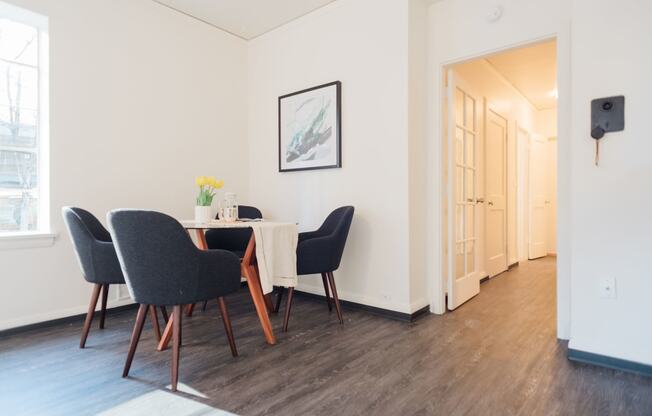 4-person dining in living area leads to hallway