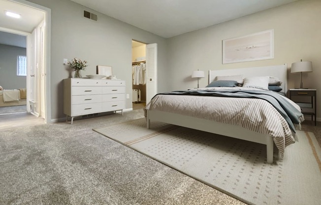 A bedroom with a bed, dresser, and nightstand.