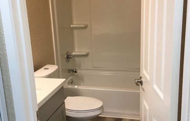 a small bathroom with a toilet and a bath tub