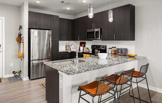 kitchen with granite countertops at the enclave at woodbridge apartments in sugar land, tx  at Abberly Noda Vista Apartment Homes, North Carolina, 28206