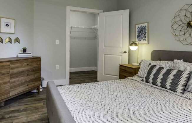 a bedroom with a bed and a closet at Echo Park at Perry Crossing Apartments, Plainfield, IN, 46168