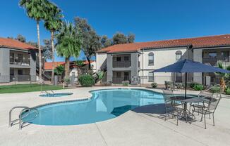 a house with a pool in front of a building