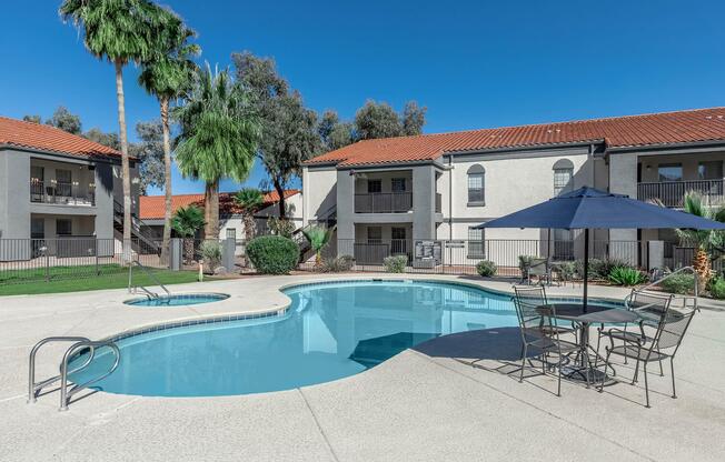 a house with a pool in front of a building