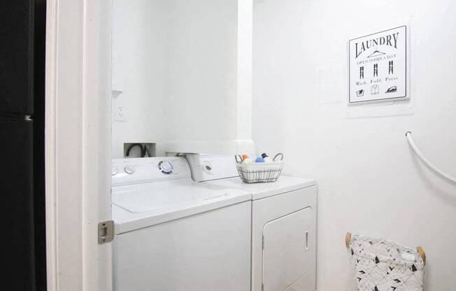 a small laundry room with a sink and a washing machine