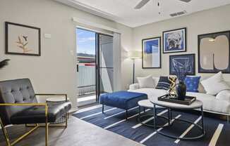 a living room with a white couch and blue rug