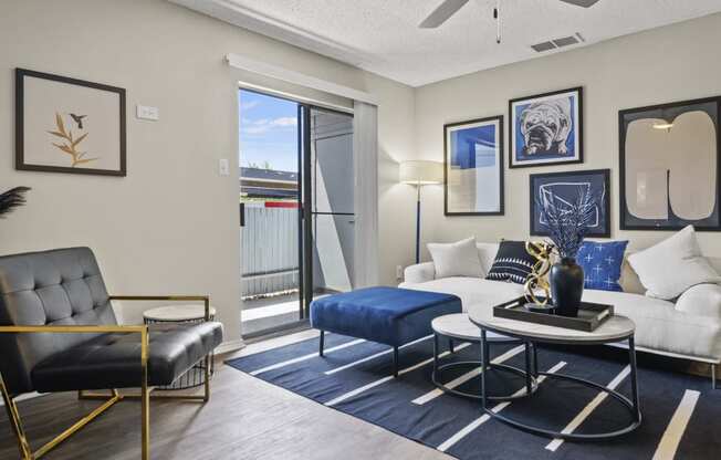 a living room with a white couch and blue rug