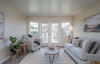 a living room with a couch and a chair and a table