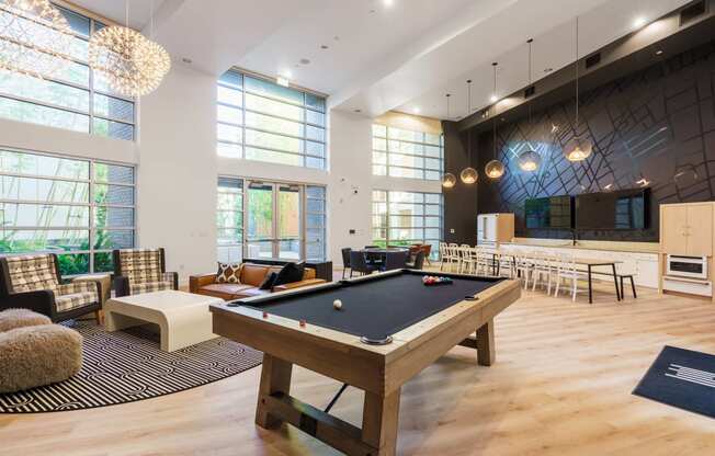 a large room with a pool table in the center of it