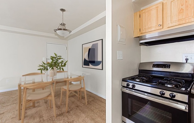 a kitchen and a dining room with a stove and a table at halley house apartments in washington dc