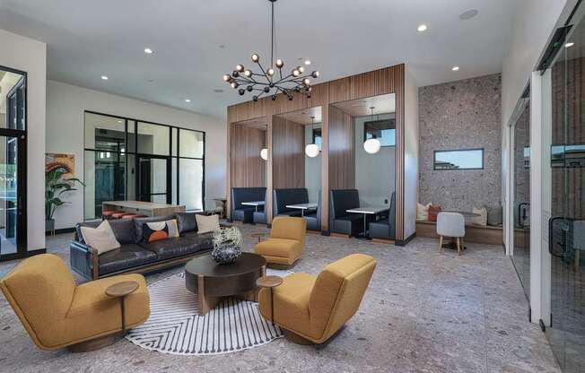 A modern living room with a sofa, chairs, and a coffee table.