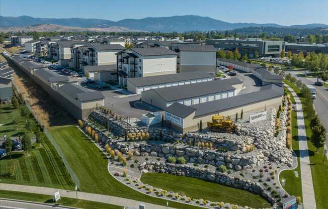 an aerial view of an industrial park with buildings and a field