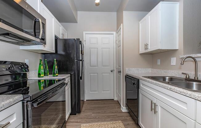a kitchen with a stove sink and refrigerator