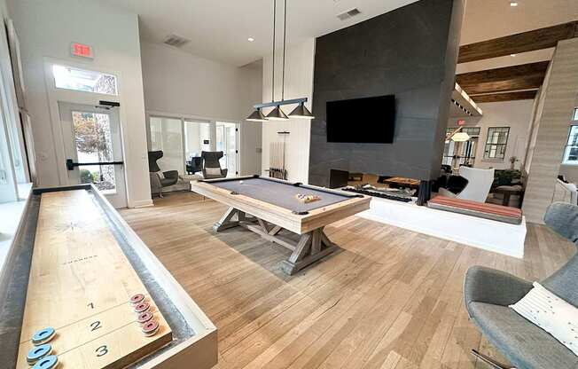 Gaming lounge with fireplace and TV