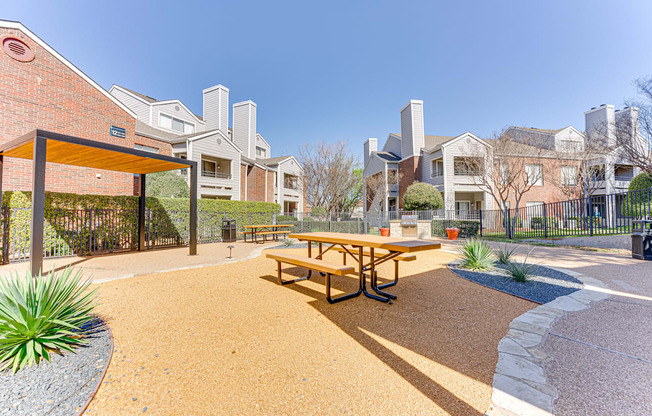 A picnic table is in the middle of a playground.