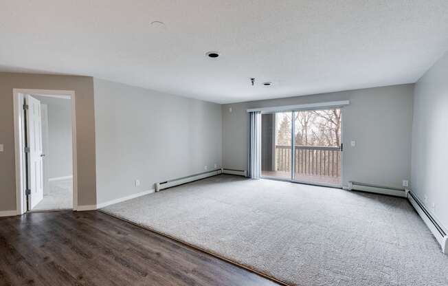 Spacious Living Room with Plush Carpeting with Sliding Patio Door to Balcony