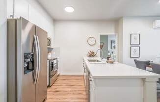 a kitchen with white quartz countertops and stainless steel appliances