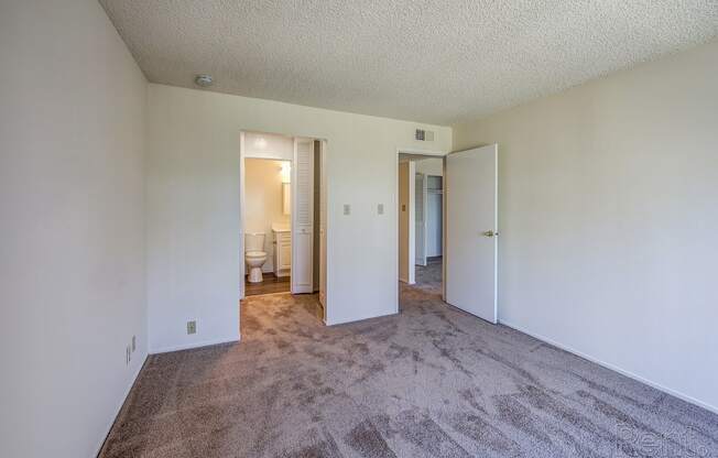 a bedroom with white walls and carpet at Terrace View Apartments, Daly City, CA