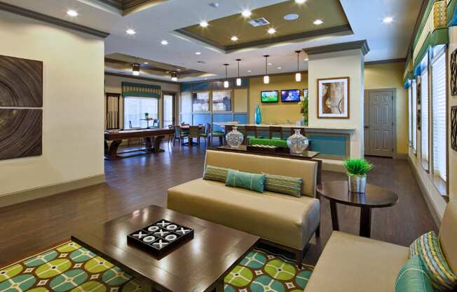 A living room with a couch, coffee table, and television.