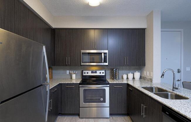 a kitchen with stainless steel appliances and a sink at Icon One, Florida
