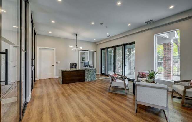 a living room with a couch and a desk and a window