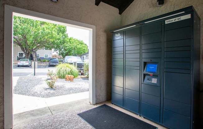 A parking garage entrance with a sign that says "Villas of QC".
