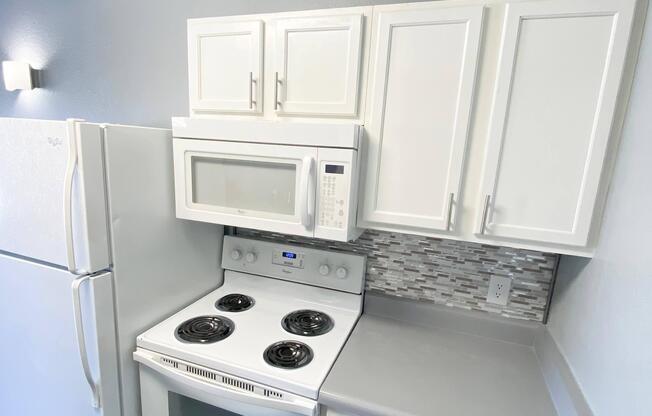 a microwave oven sitting on top of a stove