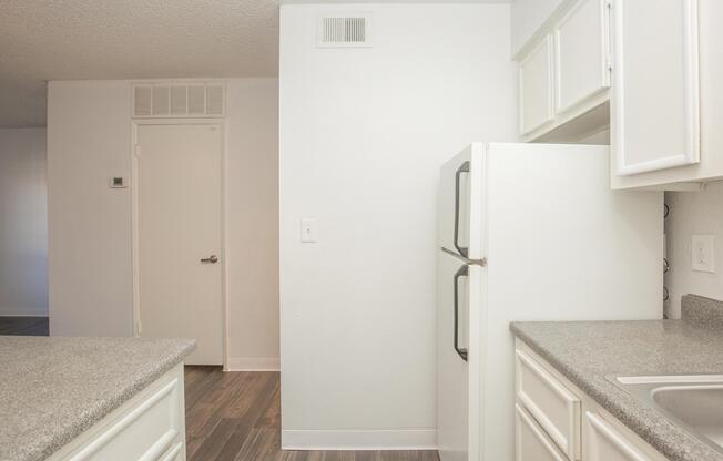 a white refrigerator freezer sitting inside of a kitchen