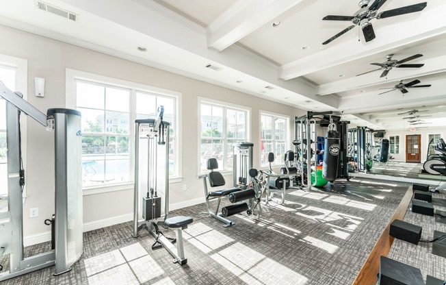 Premium fitness center with weight machines and strength equipment at Riverstone apartments for rent in Macon, GA
