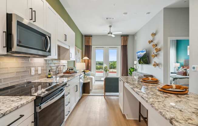 an open kitchen with granite counter tops and a marble counter top