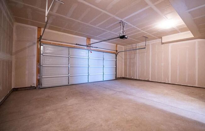 a garage with a white wall and a garage door