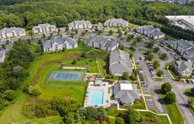 an aerial view of a neighborhood with houses and a swimming pool at The Austin Apartment Homes, Deptford, New Jersey