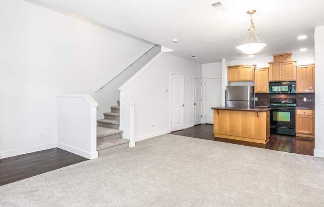 A spacious living area with a staircase leading to the upper floor at The Landing Apartments and Townhomes, Oregon, 97045