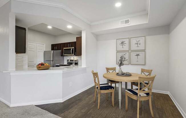 an open kitchen and dining area with a table and chairs