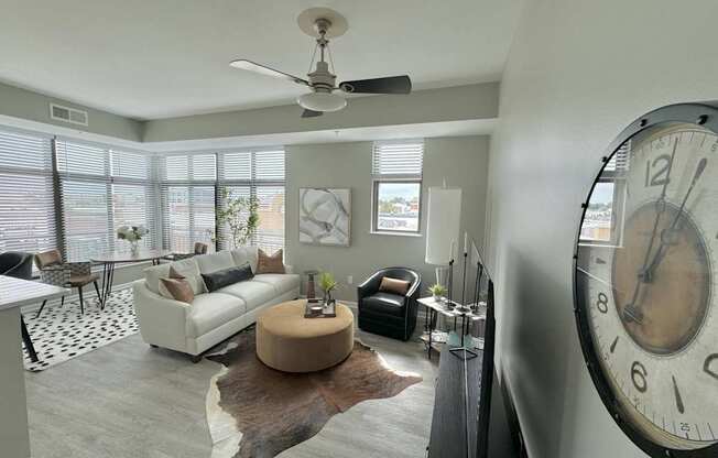 A living room with a large clock on the wall.
