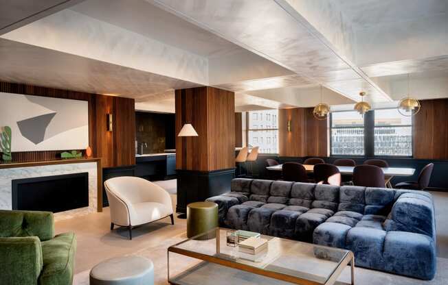 a shared amenity living room with a blue couch and a coffee tableat Book Tower, Detroit, MI, 48226