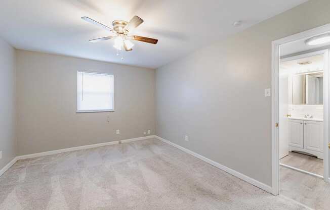 a bedroom with carpet and a ceiling fan