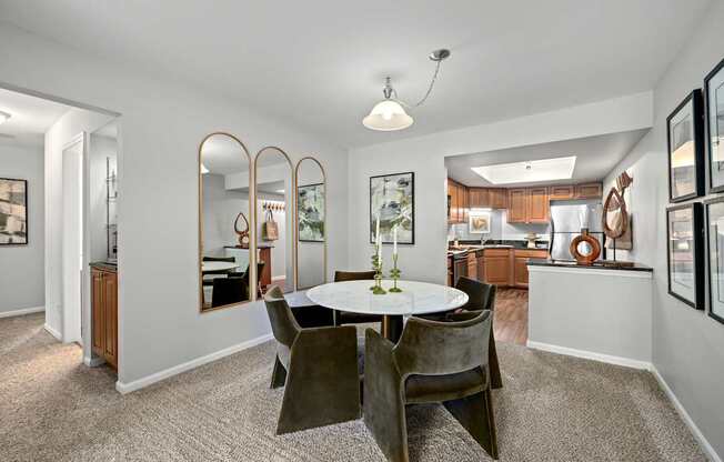 A dining room with a round table and chairs.