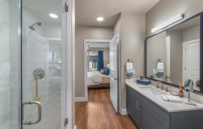 a bathroom with a large mirror and a glass shower at Presidium Revelstoke, Fort Worth, TX, 76131