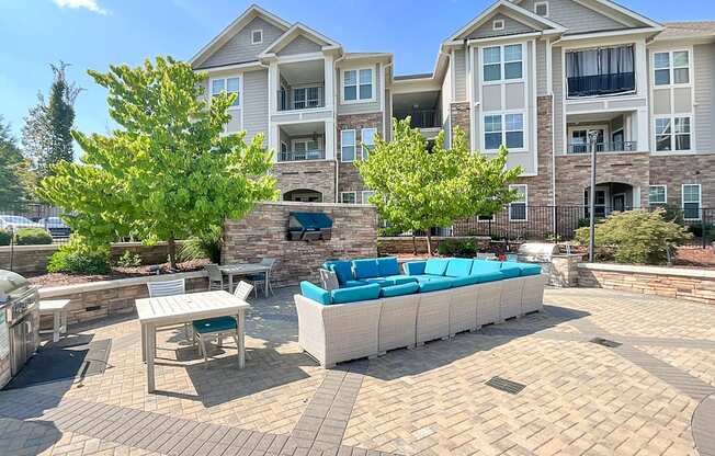 Outdoor living space for entertaining with gas grills, fire pit, entertainment lounge and game area
