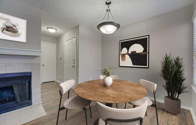 A dining room with a wooden table and chairs.