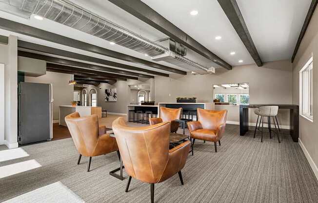 A conference room with brown leather chairs and a grey carpet.