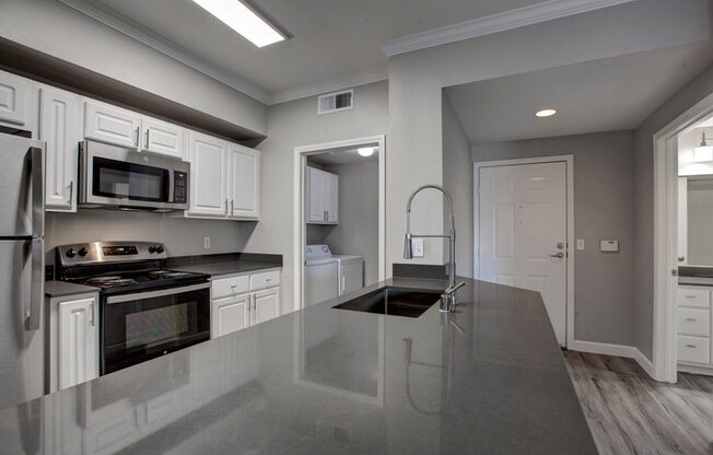 a kitchen with a large counter top and a stove top oven